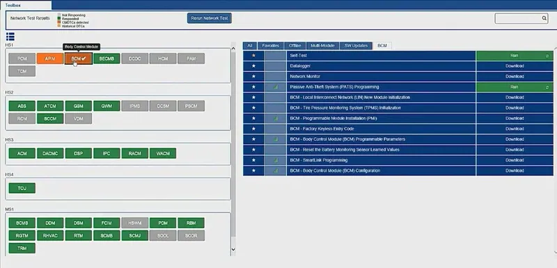 A laptop running Ford IDS diagnostic software connected to a vehicle via a J2534 pass-thru device for module programming.