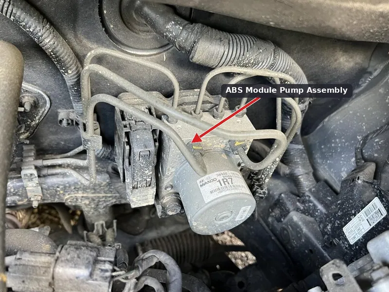 The ABS module located in the engine compartment of a 2012-2014 Hyundai Accent.