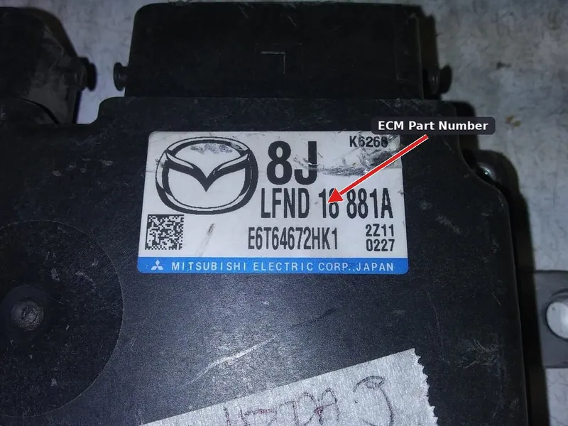 The identification label on a 2012-2013 Mazda 3 Engine Control Module showing the part number.