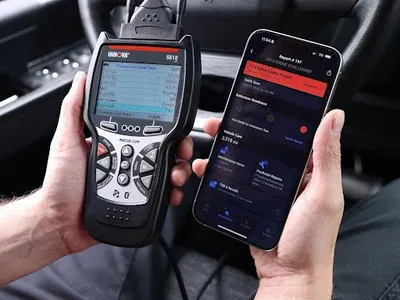 An advanced automotive diagnostic scan tool plugged into a vehicle.