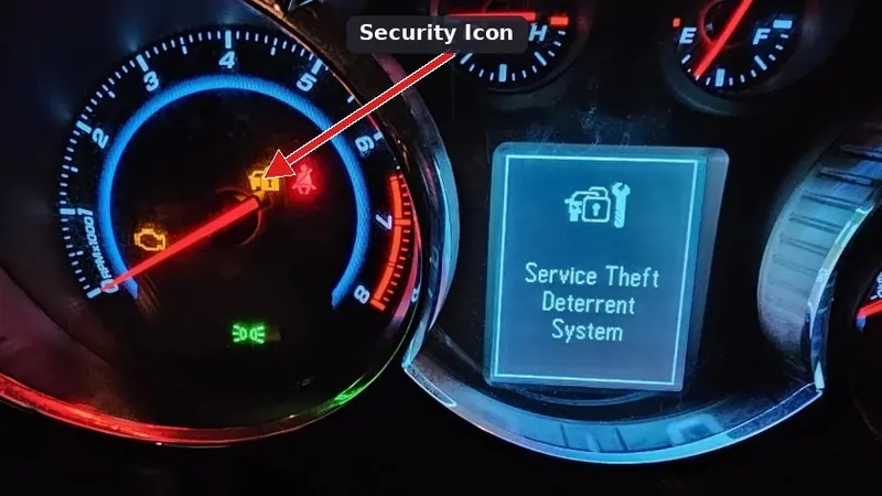 A vehicle dashboard instrument cluster with the Security or padlock warning light illuminated.