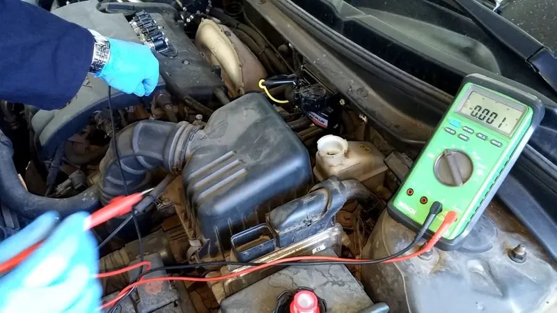A mechanic using a digital multimeter to test the electrical resistance of a brake fluid level sensor connector.