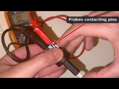 A mechanic using a multimeter to test the electrical continuity and voltage at the brake light switch connector.