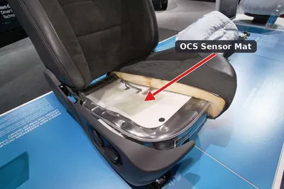 An exposed Occupant Classification System (OCS) sensor mat located under a passenger seat cushion.