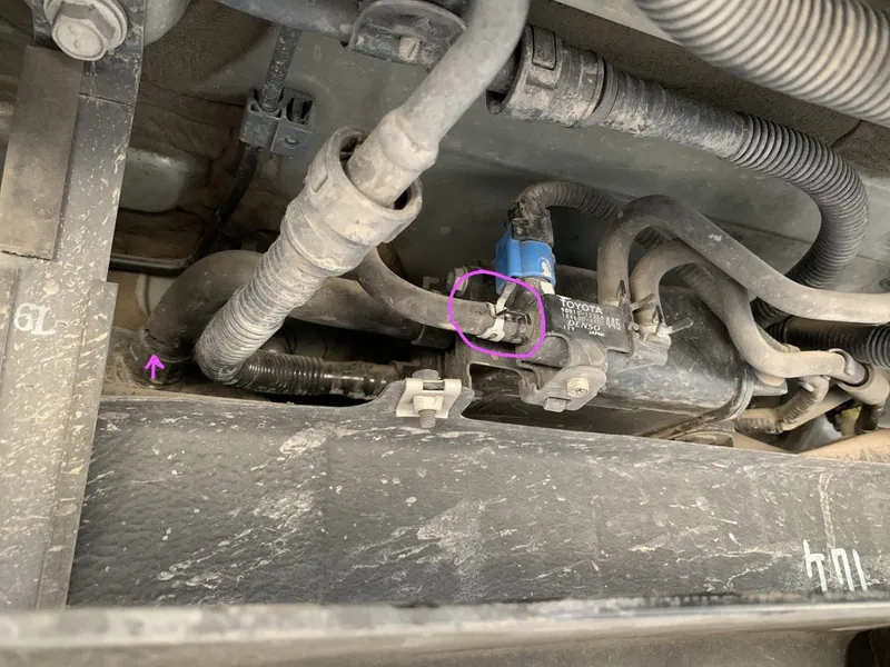 Undercarriage of a 2004-2009 Toyota Prius showing the rear axle and EVAP canister area.