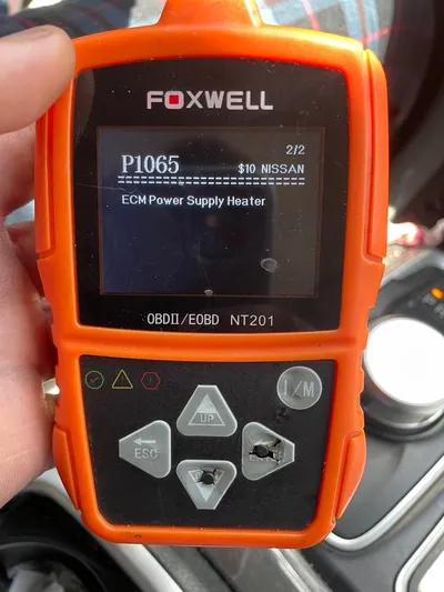 An OBD2 diagnostic scanner displaying the P1065 trouble code