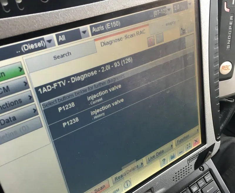 An OBD2 scanner displaying the P1238 diagnostic trouble code.