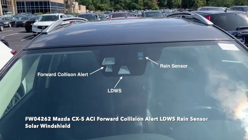 2017-2020 Mazda CX-5 showing the location of the Forward Sensing Camera behind the rearview mirror