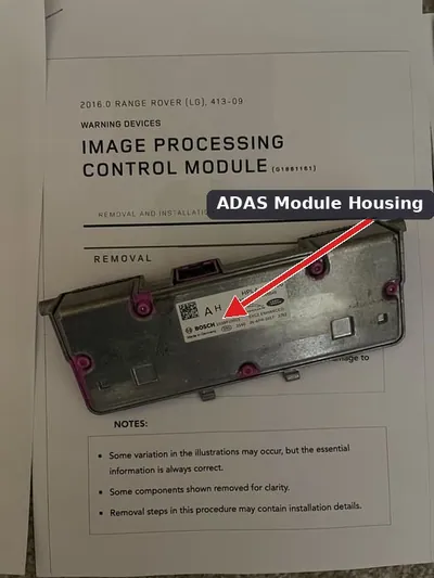 A front-facing Advanced Driver Assist System (ADAS) camera module mounted behind a vehicle's rearview mirror.