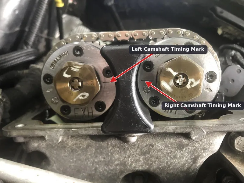 A mechanic working on the timing chain alignment of a Dodge Durango engine.