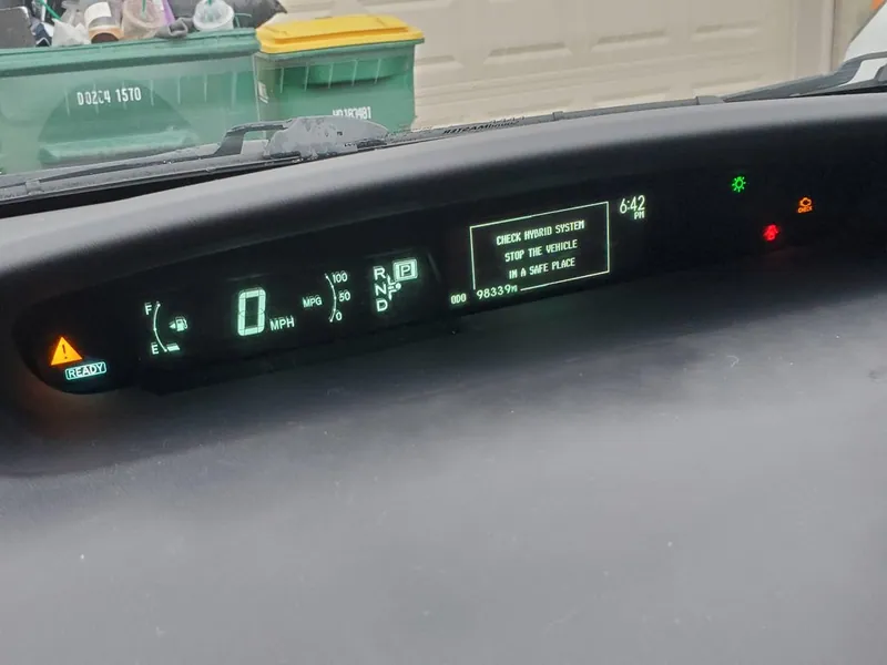 A hybrid vehicle inverter assembly located in the engine bay.